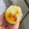 The natural raw mineral white flower cleverly carved and colorful honey wax money bag pendant is approximately 36.6x31.9x29.4mm in size0811790133