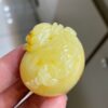 The natural raw mineral white flower cleverly carved and colorful honey wax money bag pendant is approximately 36.6x31.9x29.4mm in size0811790133